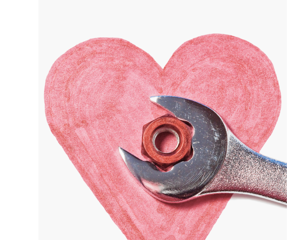 Close up of a spanner fixing a drawing of a heart