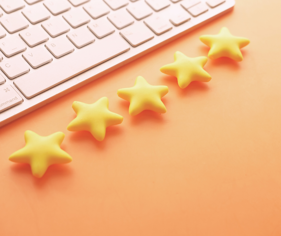 Five yellow stars by a laptop against an orange background