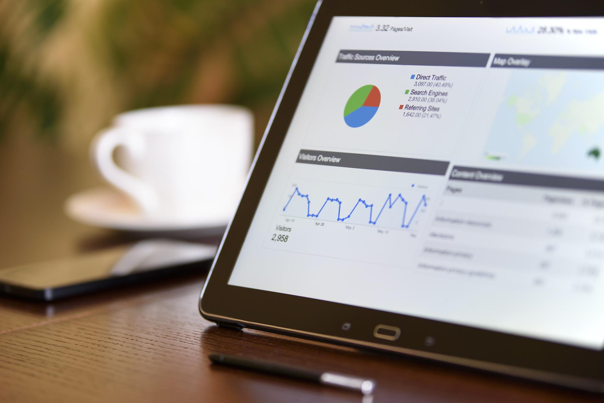 Tablet on an office desk showing business information. Working out the financial for a counselling service's business plan.