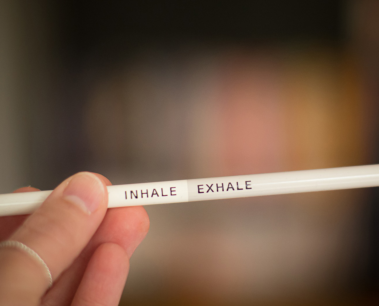 White pencil with the words Inhale Exhale written on it
