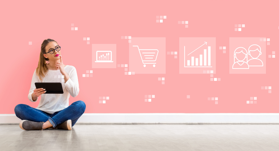 Young woman sitting cross-legged on the floor with ipad in hand & in thinking pose against a pink background with business icons across the wall