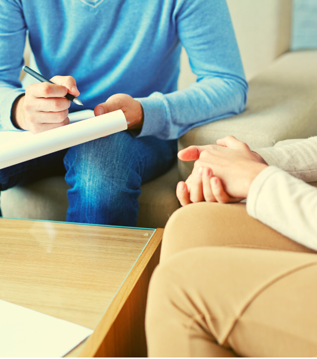 Male therapist takes notes while he talks to his counselling client