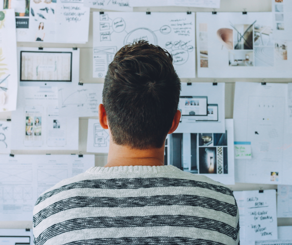 Man standing in front of whiteboard considering his options