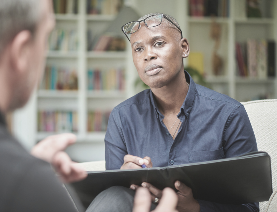 Male therapist listens intently to his male counselling client
