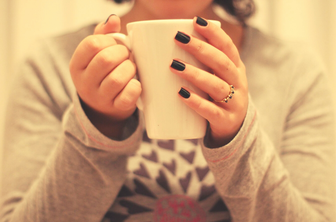 Close up of woman holding cup of tea 