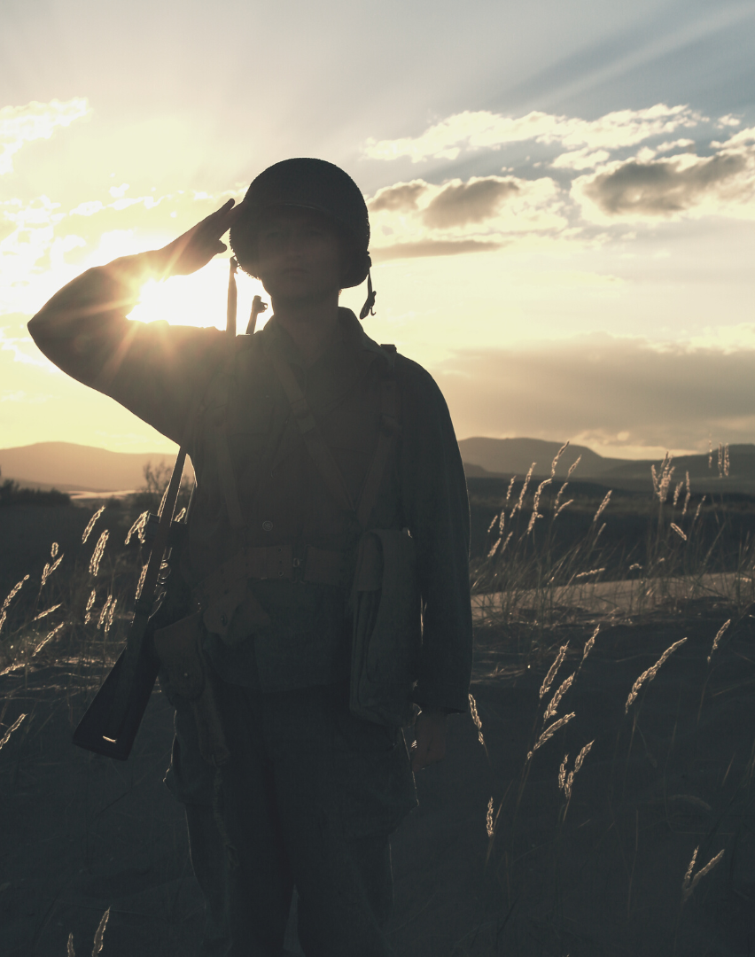 Shadow outline of soldier saluting in a cornfield