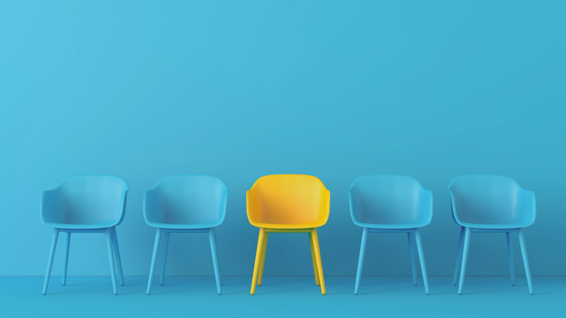 Row of blue chairs with yellow chair in the centre