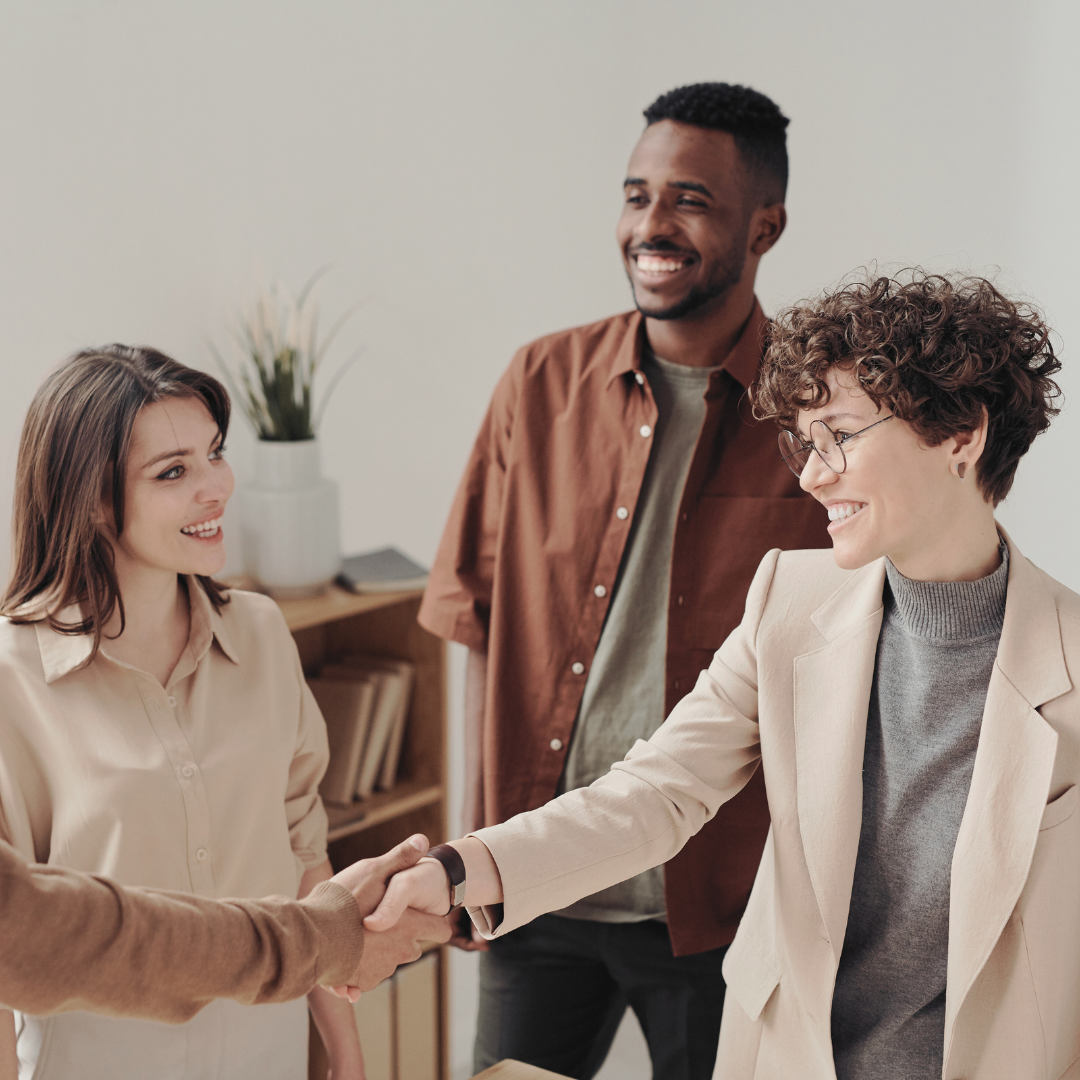 Female therapist shakes hand of her counselling client