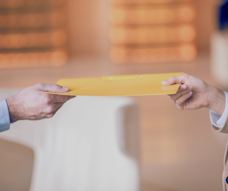 Close up of woman handing a man a document