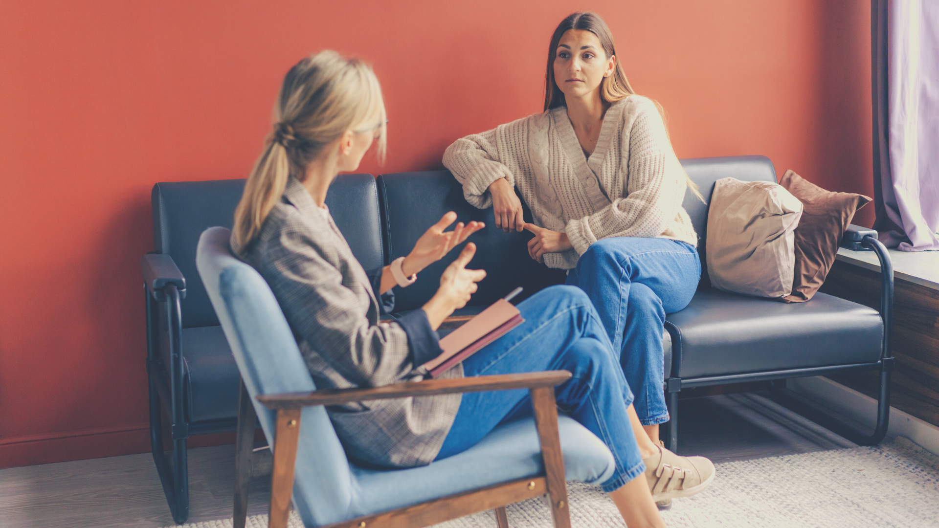 A female psychologist talks with her female client in a counselling session